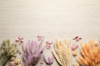 Photo of Flat lay composition with beautiful dried flowers on white wooden background. Space for text
