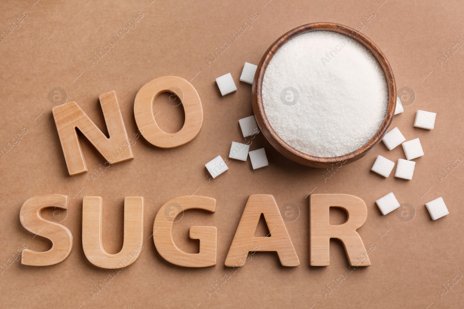 Photo of Flat lay composition with phrase No Sugar on brown background