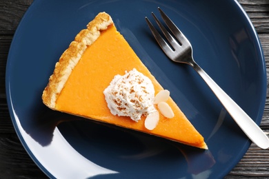 Piece of fresh delicious homemade pumpkin pie on plate, top view