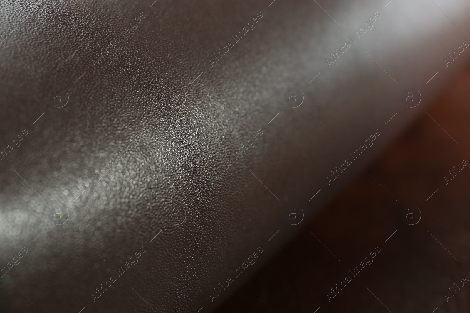 Photo of Dark brown natural leather as background, closeup view