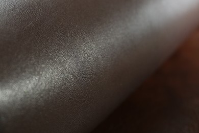 Photo of Dark brown natural leather as background, closeup view