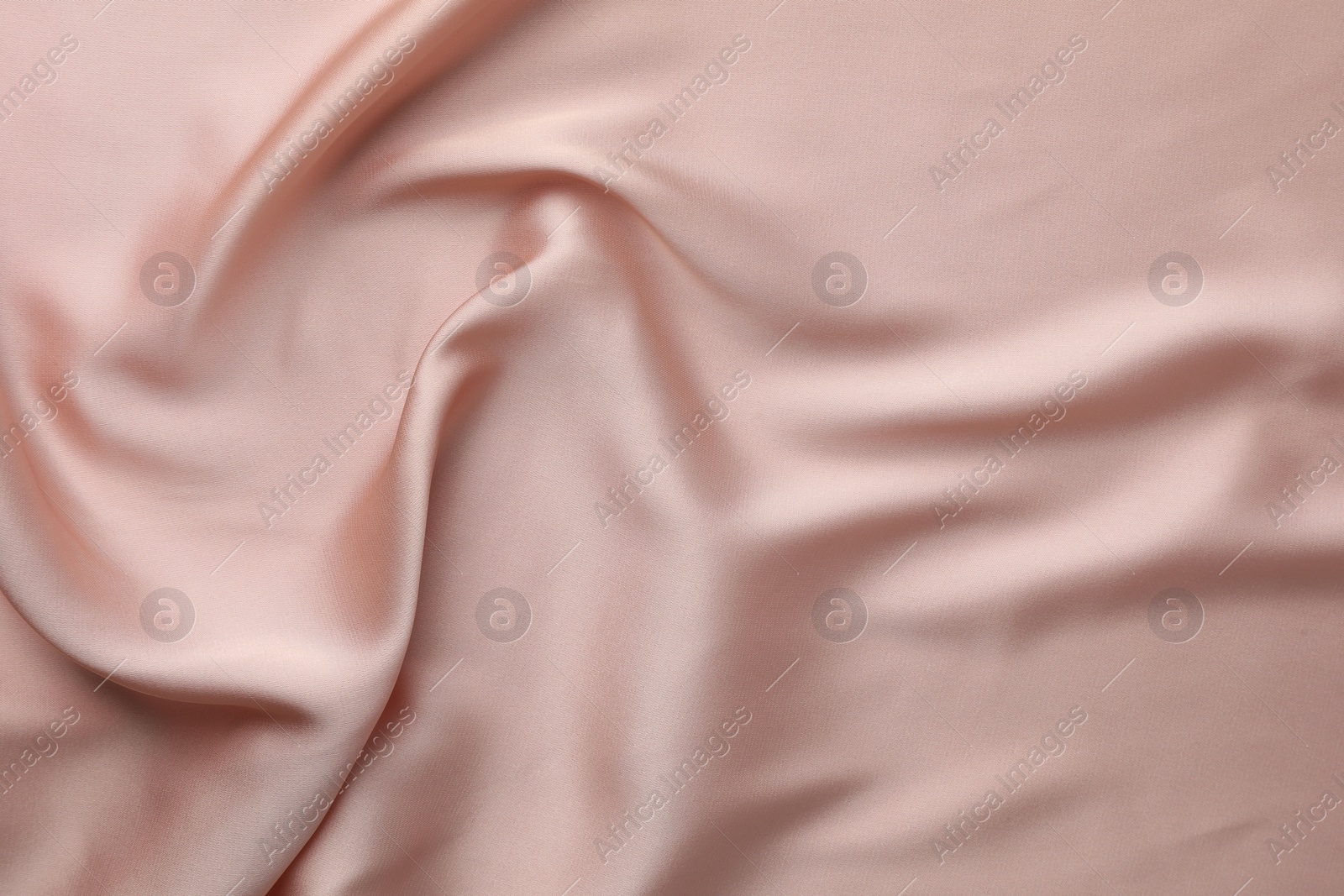 Photo of Crumpled pink silk fabric as background, top view