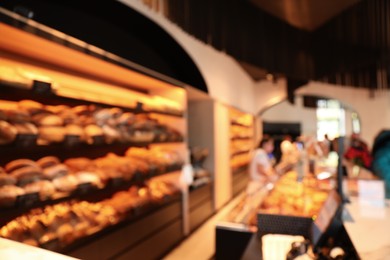 Blurred view of fresh pastries on counter in bakery store