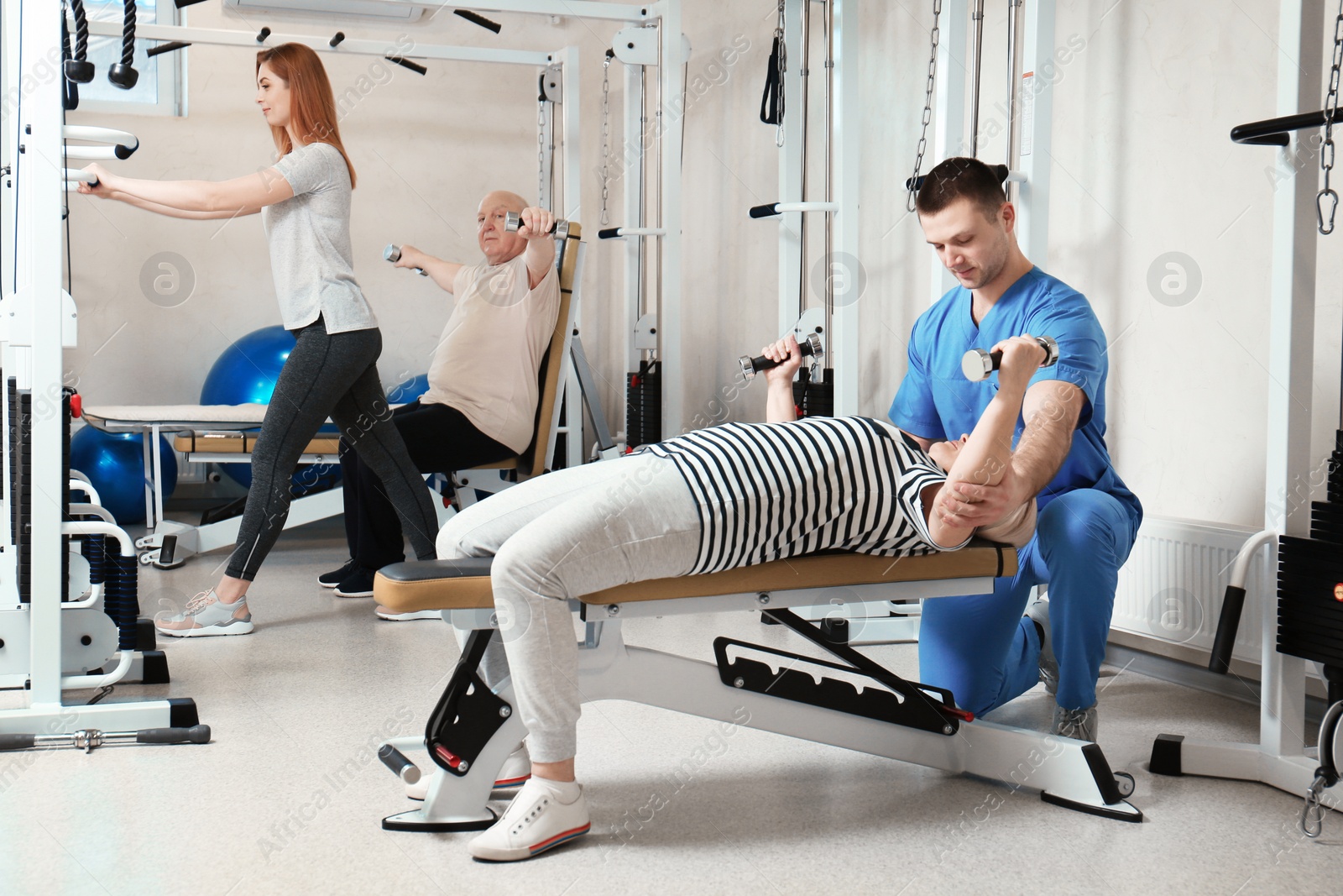 Photo of Patient exercising under physiotherapist supervision in rehabilitation center