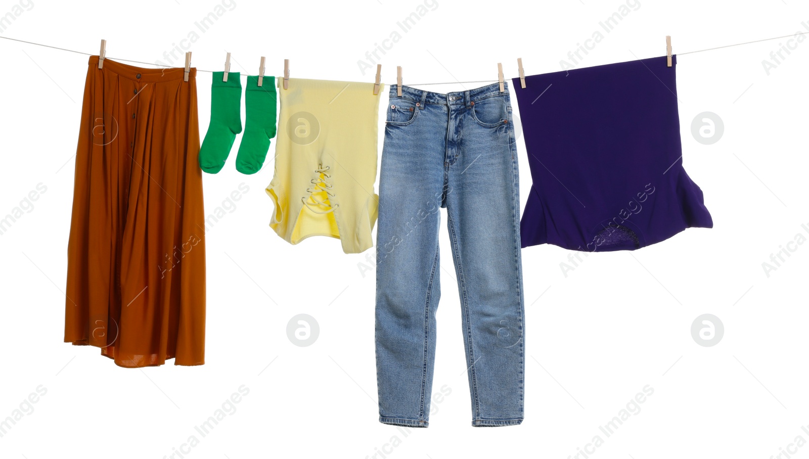 Photo of Different clothes drying on laundry line against white background