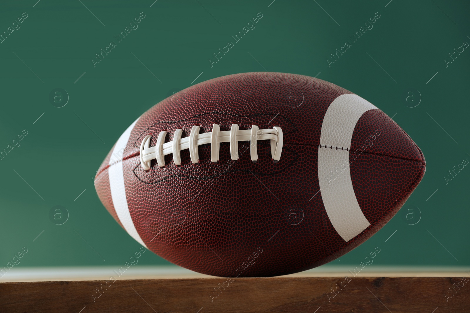 Photo of American football ball against blurred game scheme