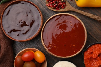 Photo of Different marinades and products on wooden table, flat lay