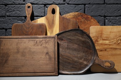Photo of Set of different wooden cutting boards on table