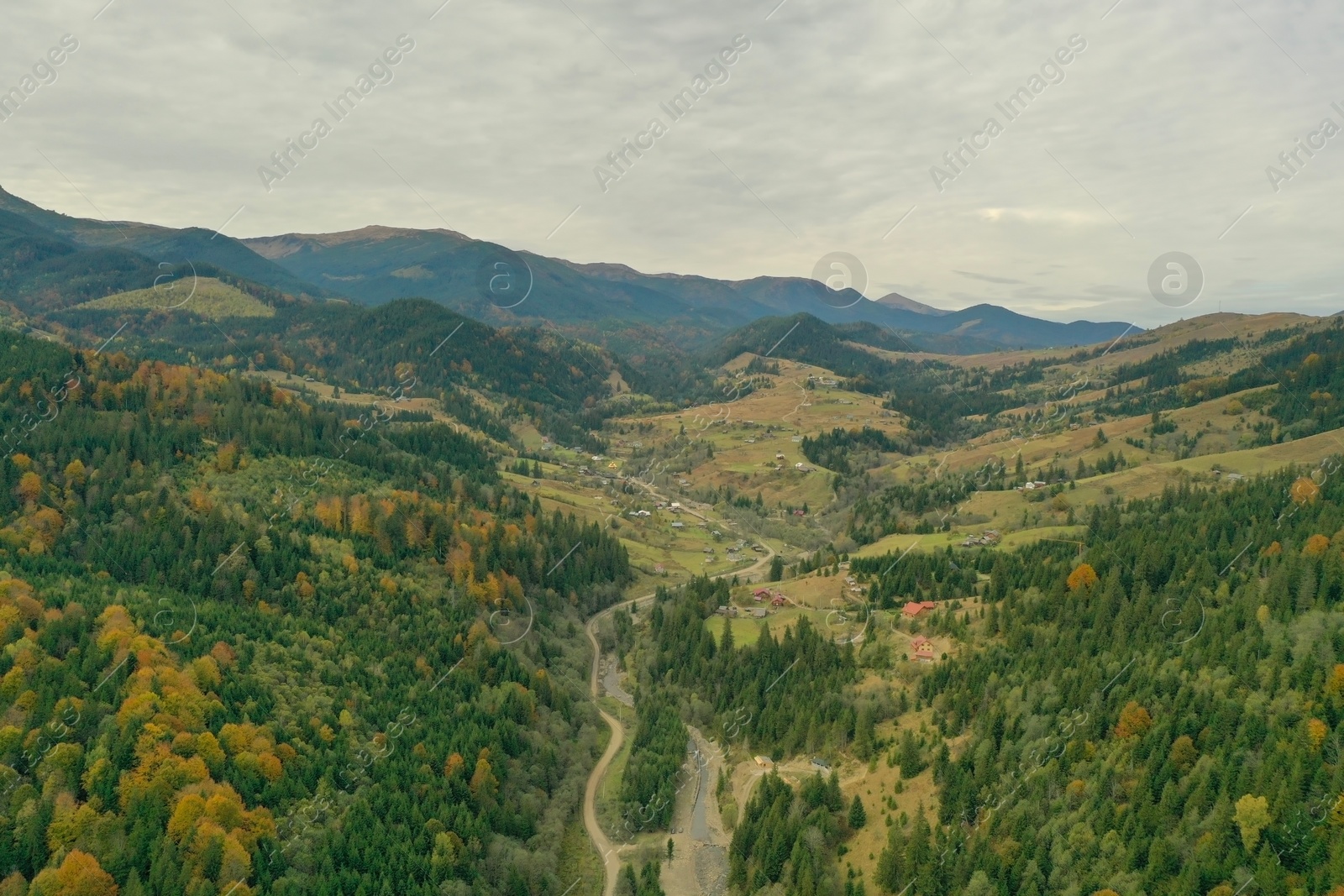 Photo of Aerial view of beautiful mountain forest and village on autumn day
