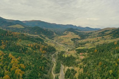 Photo of Aerial view of beautiful mountain forest and village on autumn day