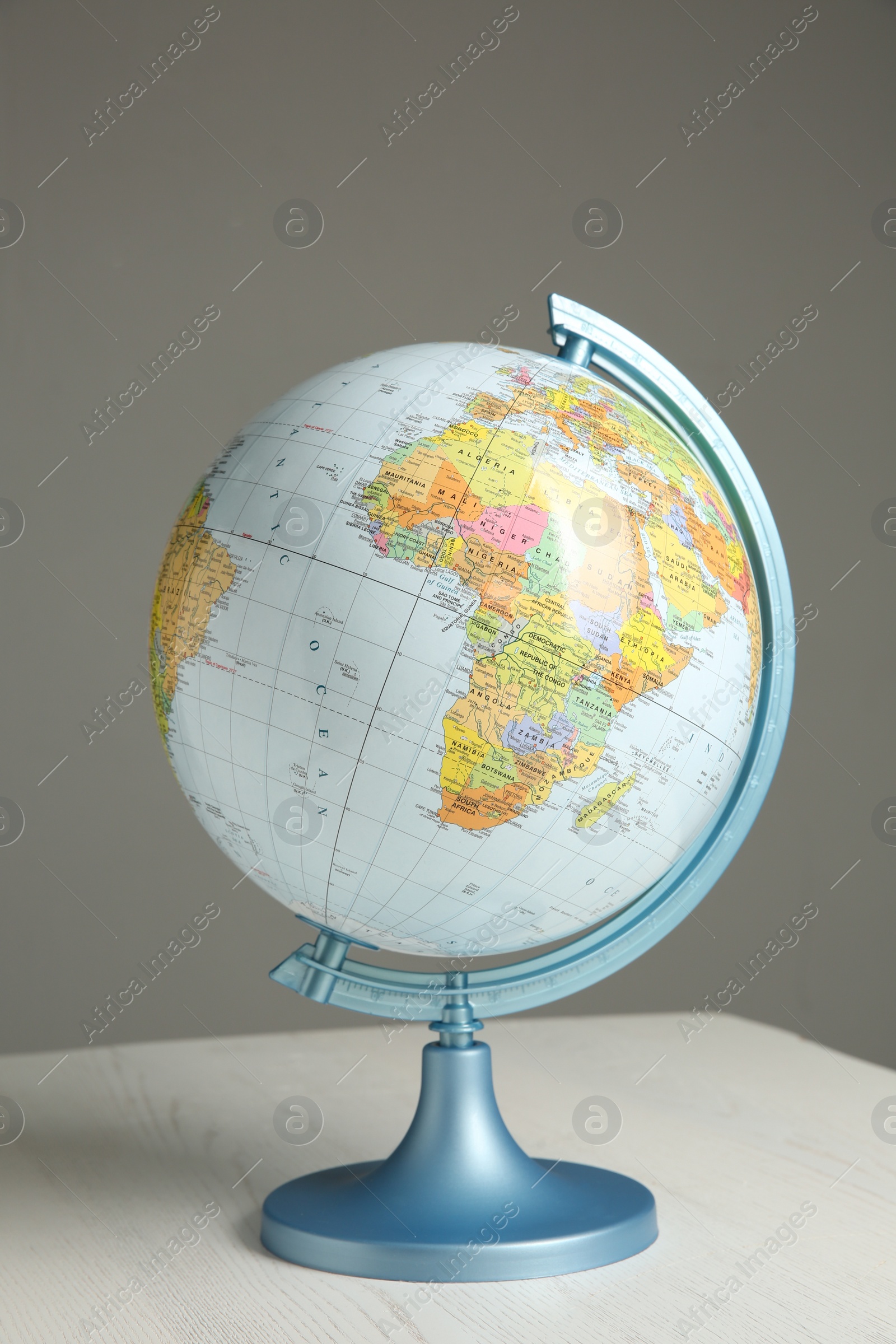 Photo of World globe on white wooden table. Educational model