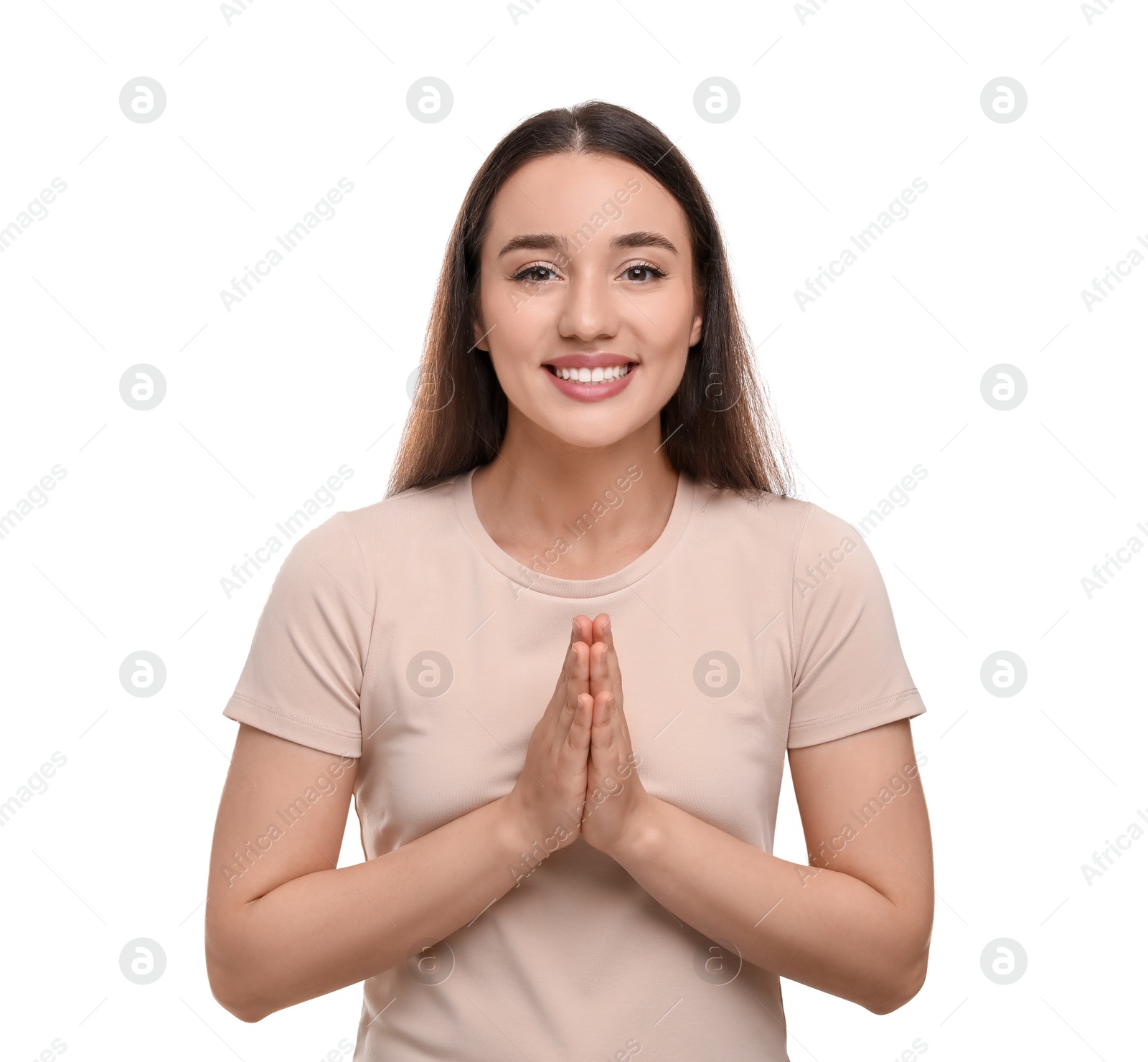 Photo of Thank you gesture. Beautiful grateful woman with hands clasped together on white background