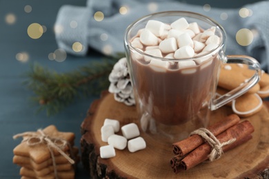 Photo of Composition with hot drink, marshmallows, cinnamon and cookies on table