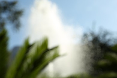 Photo of Blurred view of water fountain on sunny day outdoors. Bokeh effect