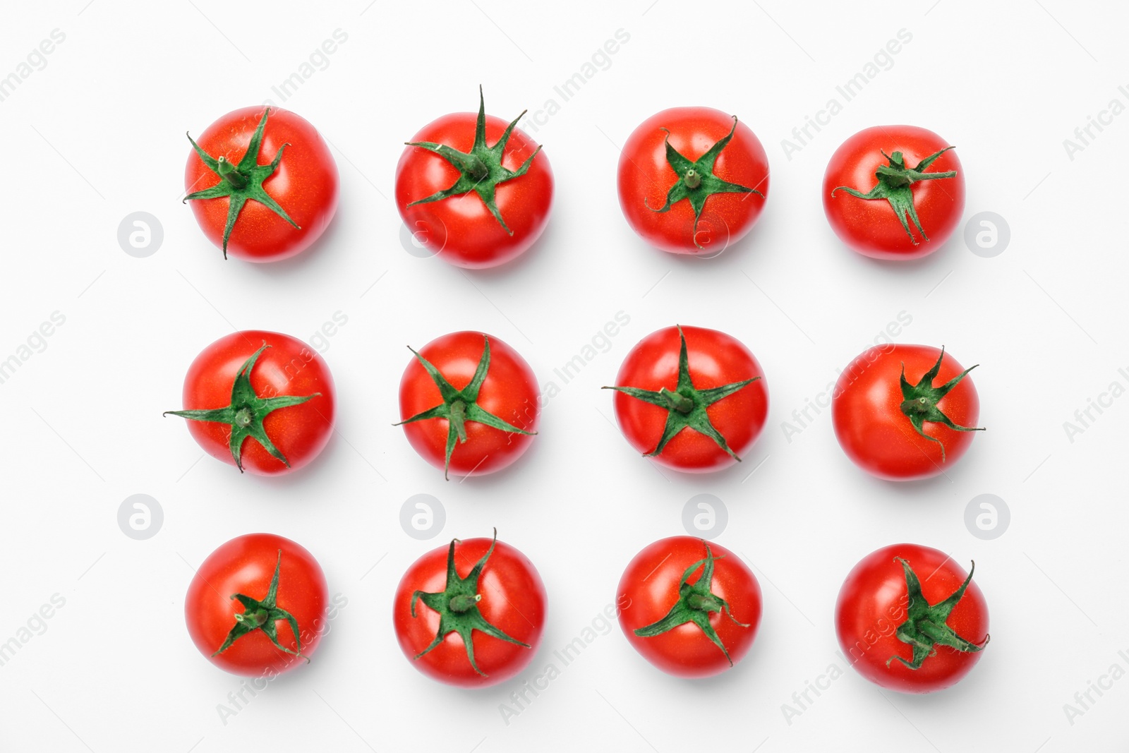 Photo of Flat lay composition with ripe tomatoes on light background