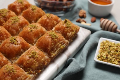 Photo of Delicious sweet baklava with pistachios on table, closeup