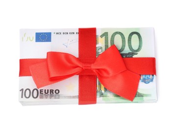 Photo of 100 Euro banknotes with red ribbon isolated on white, top view. Money exchange
