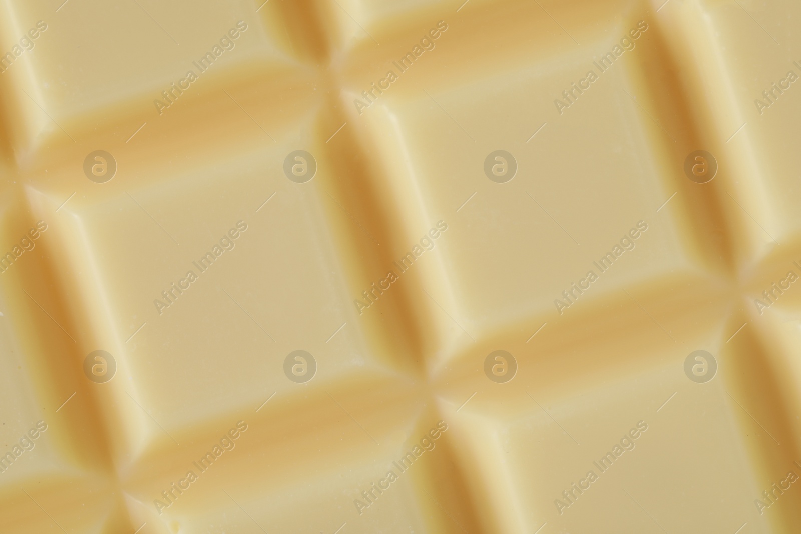 Photo of Delicious white chocolate as background, closeup view