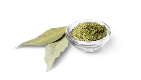 Whole and ground aromatic bay leaves on white background