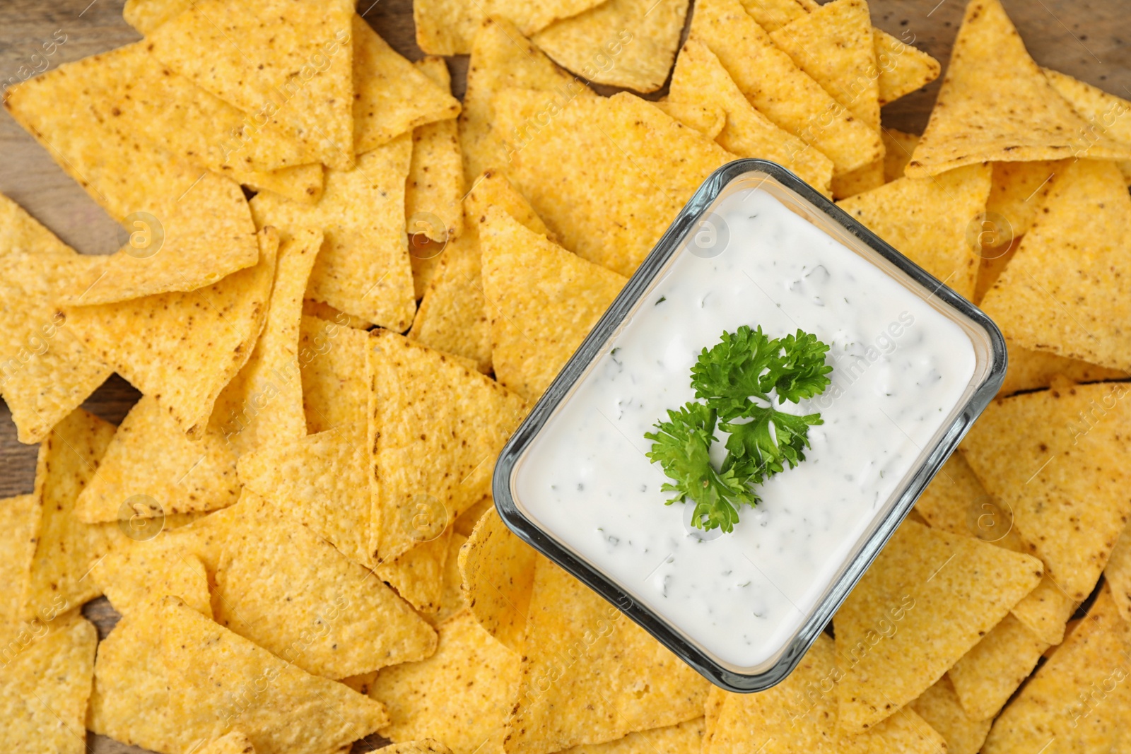 Photo of Mexican nacho chips with sauce on table, top view