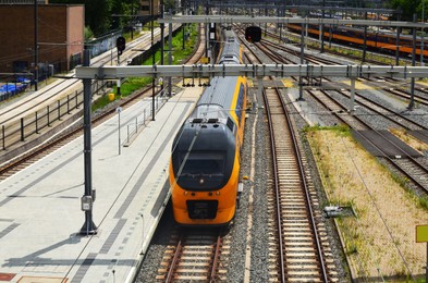 Railway lines and modern trains on sunny day