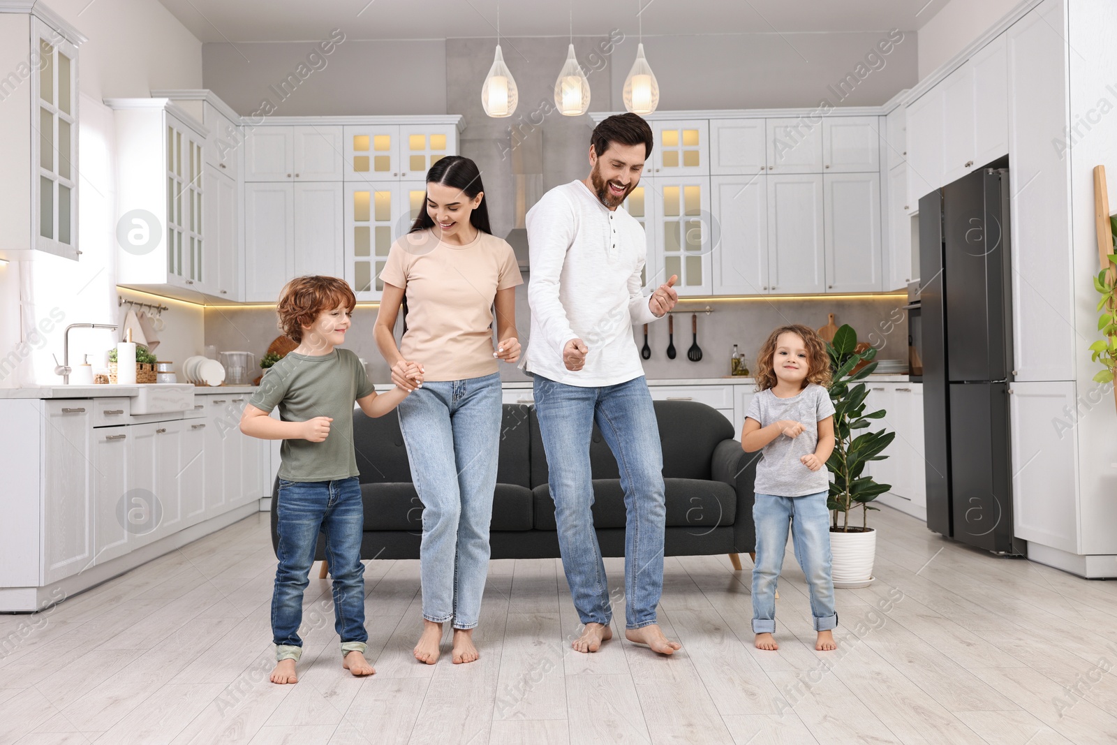 Photo of Happy family dancing and having fun at home