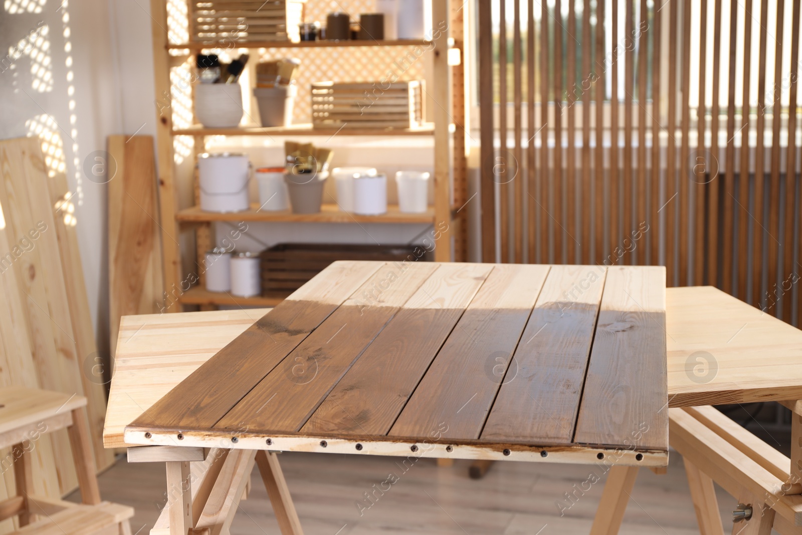 Photo of Wooden surface after applying wood stain in workshop