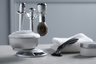 Set of men's shaving tools on grey table. Space for text