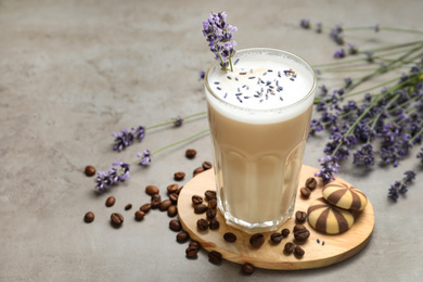 Photo of Delicious coffee with lavender and cookies on grey table. Space for text