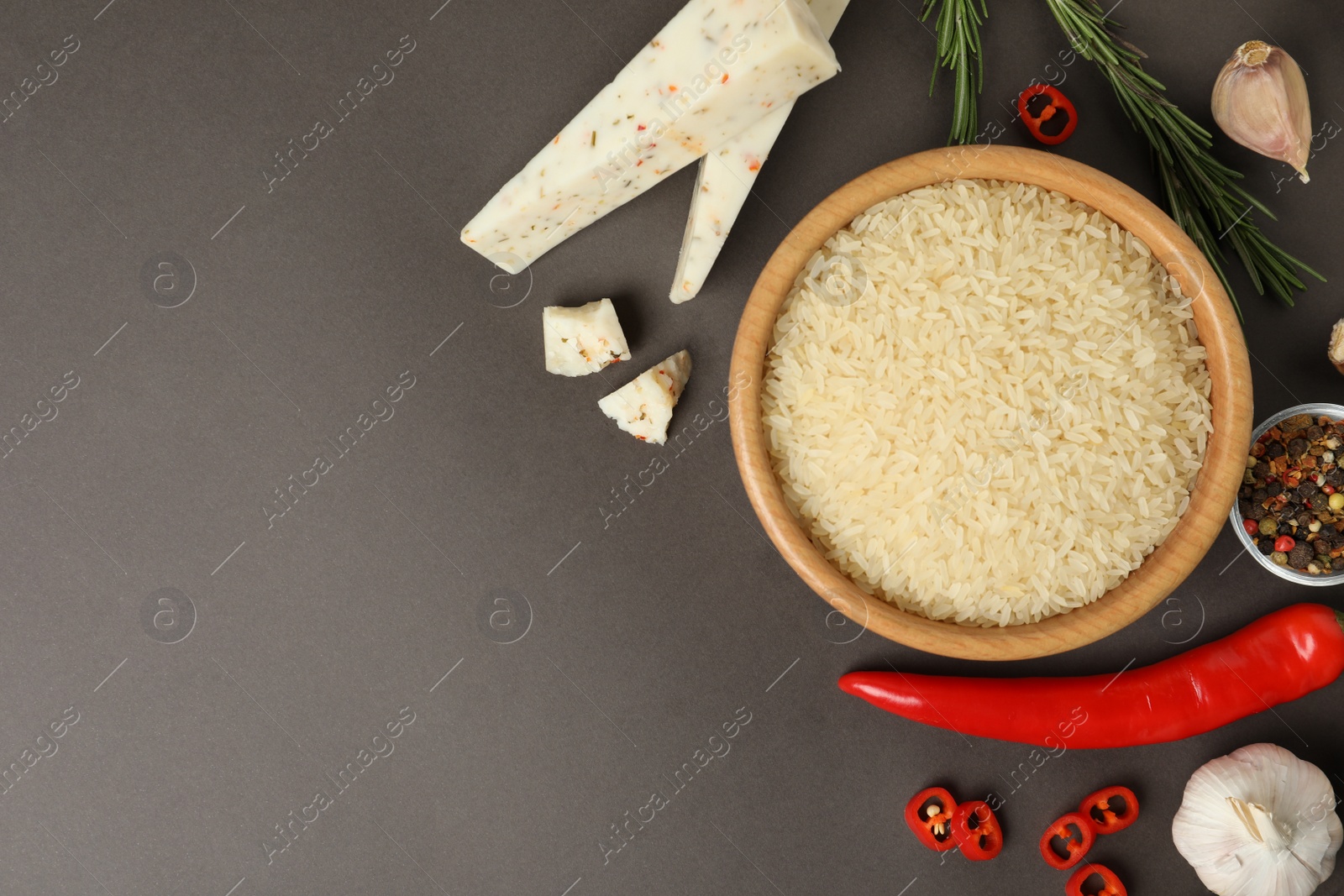 Photo of Flat lay composition with different ingredients on grey background, space for text. Risotto recipe