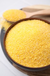 Photo of Raw cornmeal in bowl on white table, above view