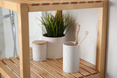 Photo of Shelving unit with toiletries in bathroom interior