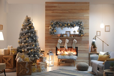 Photo of Beautiful living room interior with decorated Christmas tree and fireplace