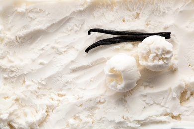 Photo of Tasty vanilla ice cream and sticks, closeup