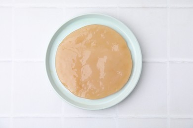 Making kombucha. Scoby fungus on white tiled table, top view