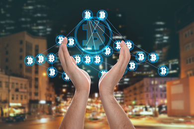 Fintech concept. Woman demonstrating scheme with Bitcoin symbols against blurred cityscape
