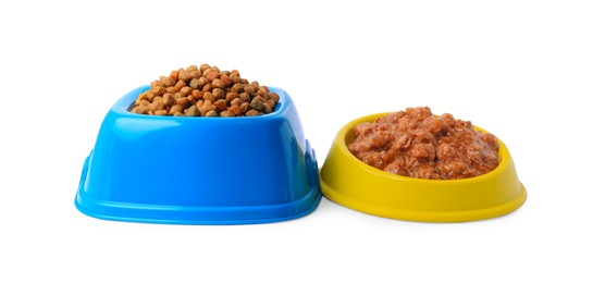 Dry and wet pet food in feeding bowls on white background