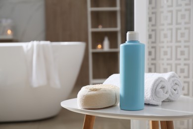 Photo of Bottle of shower gel, sponge and fresh towels on white table in bathroom. Space for text