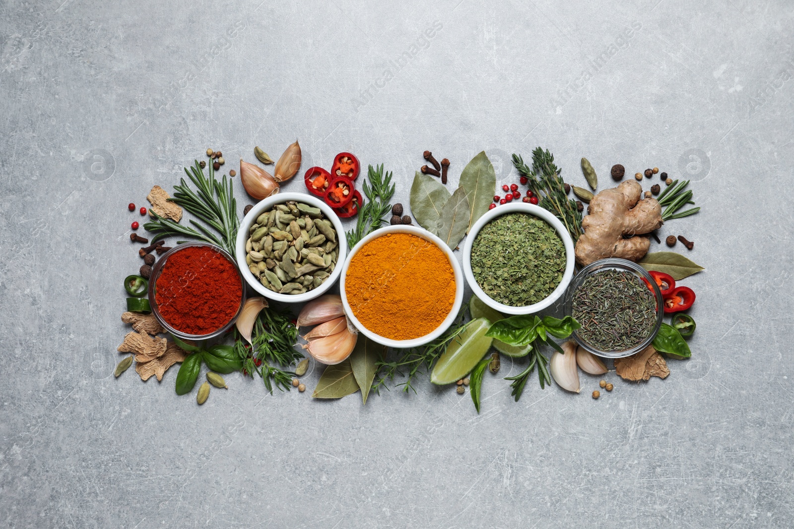 Photo of Flat lay composition with different natural spices and herbs on light grey table
