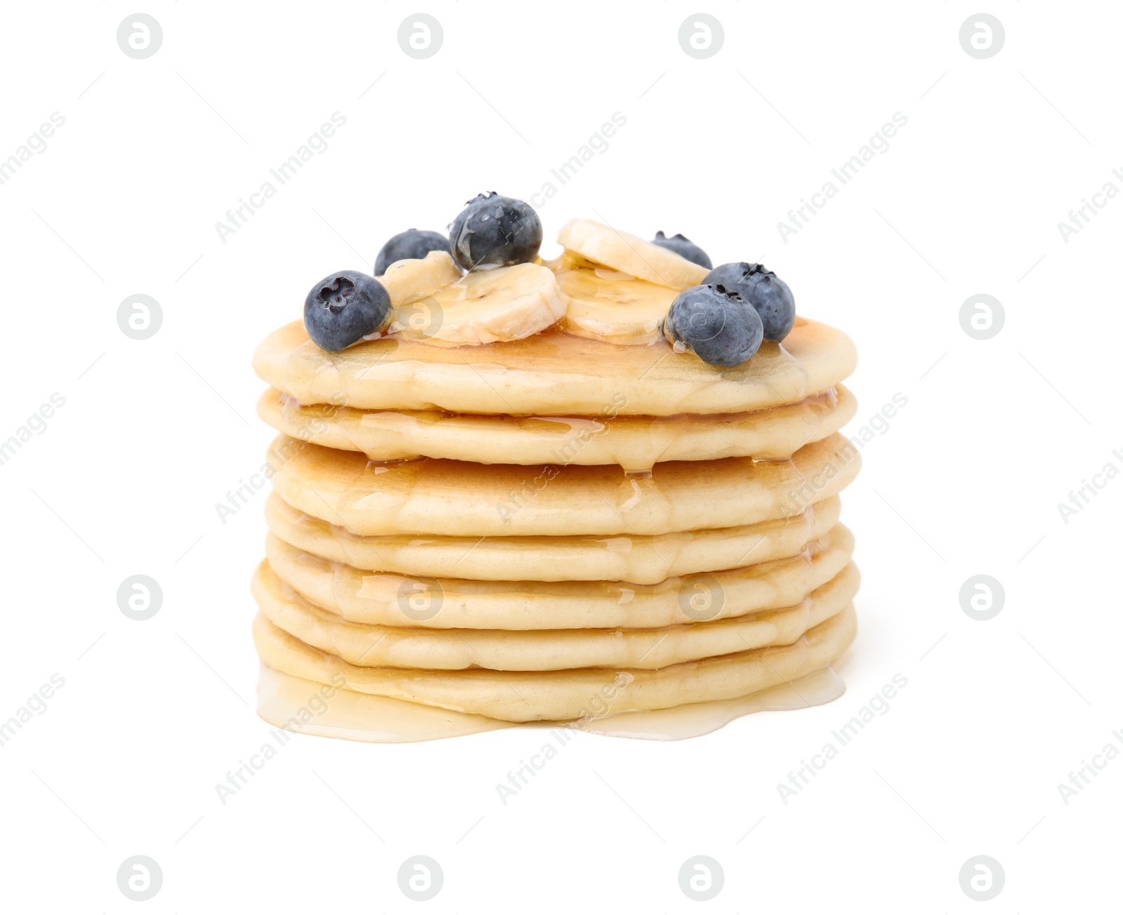 Photo of Delicious pancakes with banana slices, blueberries and honey isolated on white
