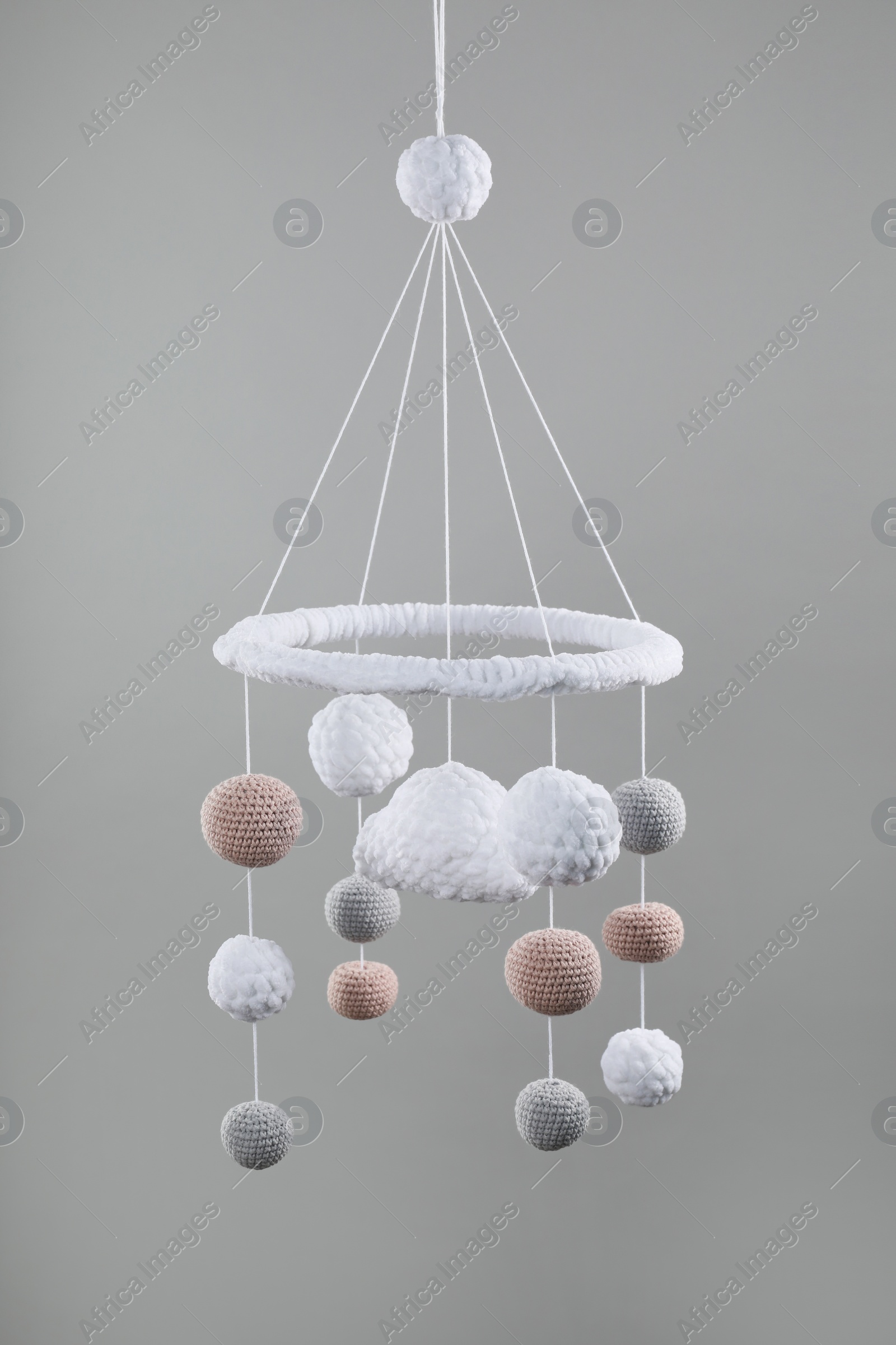 Photo of Cute baby crib mobile on grey background