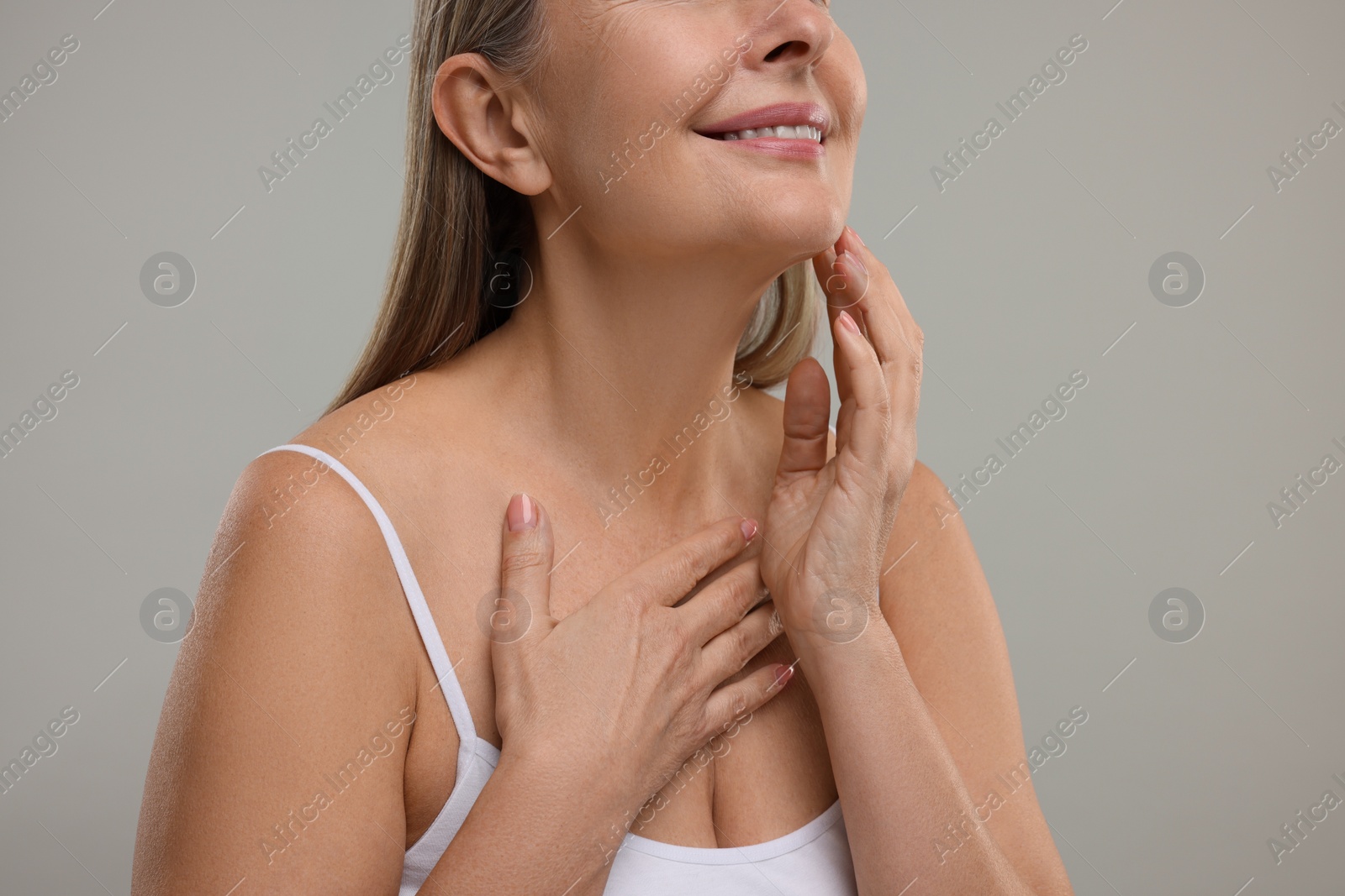 Photo of Mature woman with healthy skin on grey background, closeup