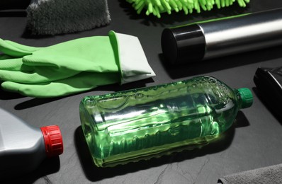 Car cleaning products and gloves on grey table