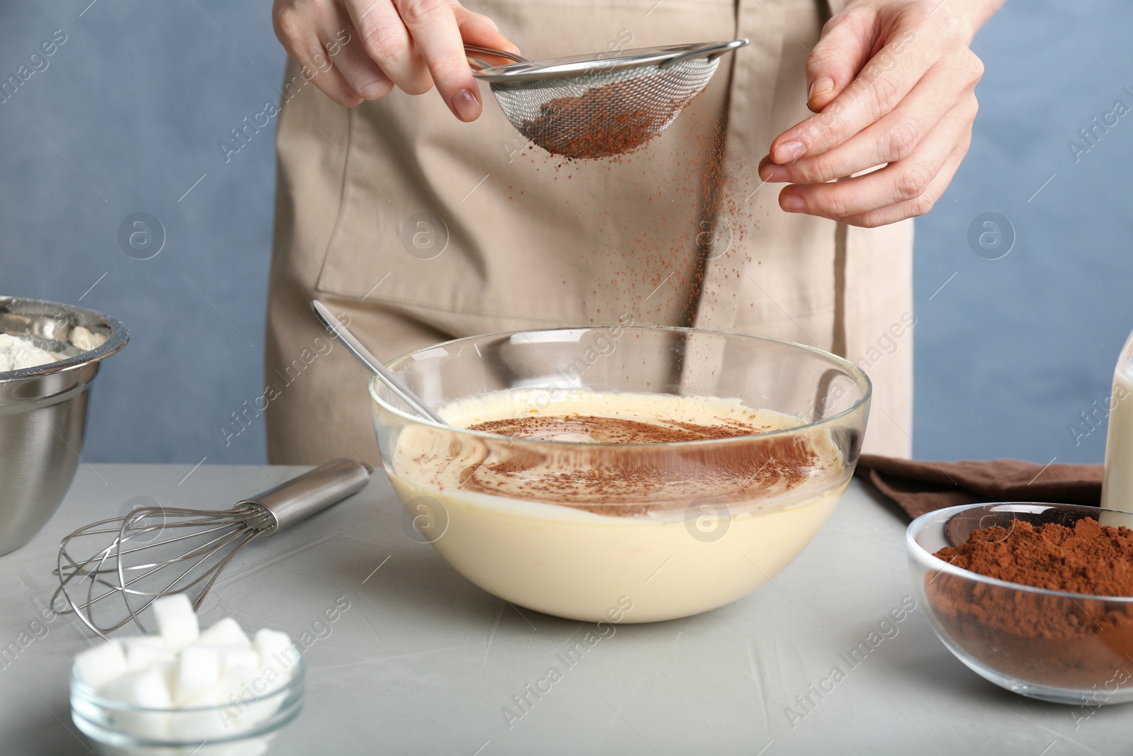 Photo of Woman making batter at light table, closeup