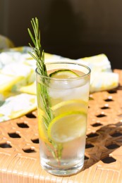 Photo of Tasty refreshing lemonade on wicker bench. Summer drink