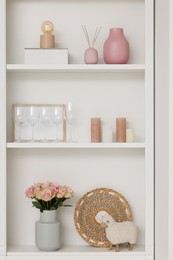 Shelves with different decor indoors. Interior design