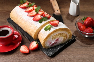 Delicious cake roll with strawberries and cream on wooden table