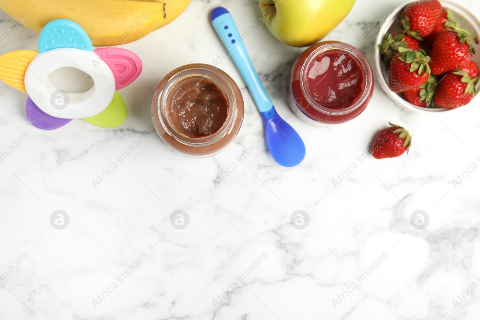 Photo of Healthy baby food in jars and fresh ingredients on white marble table, flat lay. Space for text