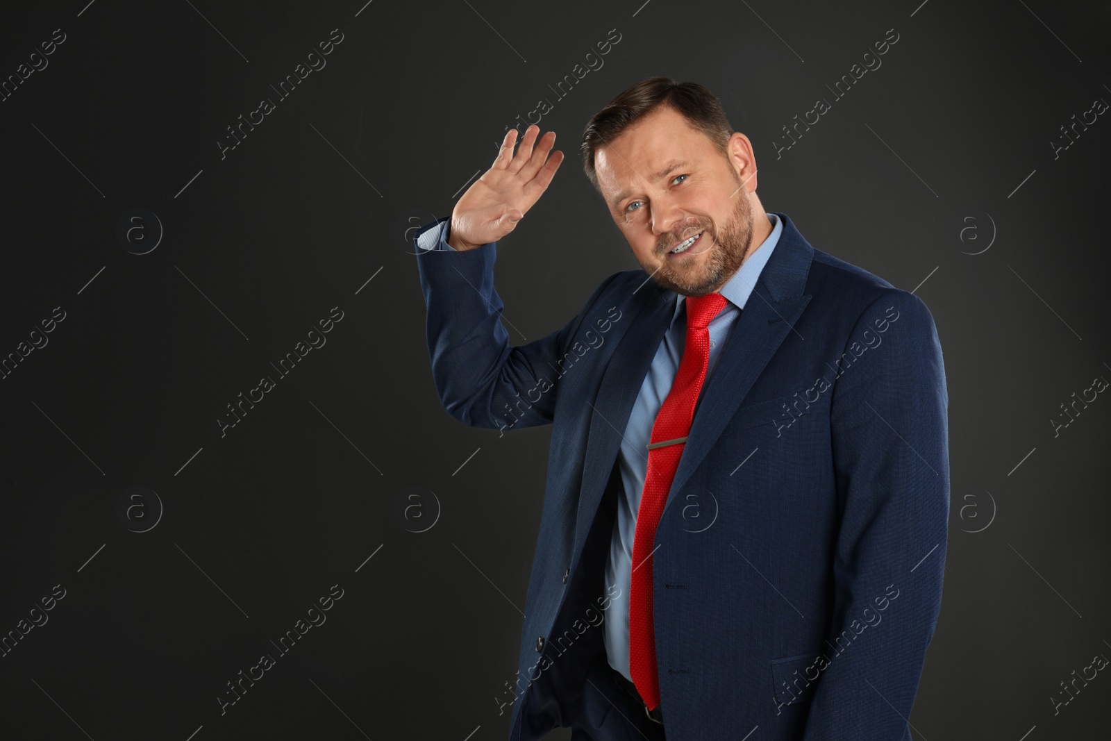 Photo of Portrait of emotional mature man on black background