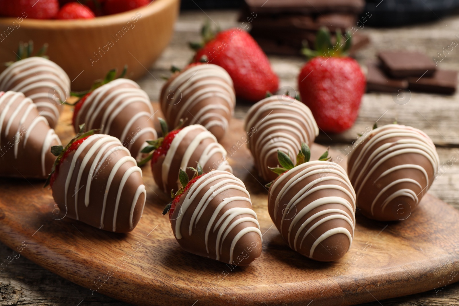 Photo of Delicious chocolate covered strawberries on wooden table, closeup